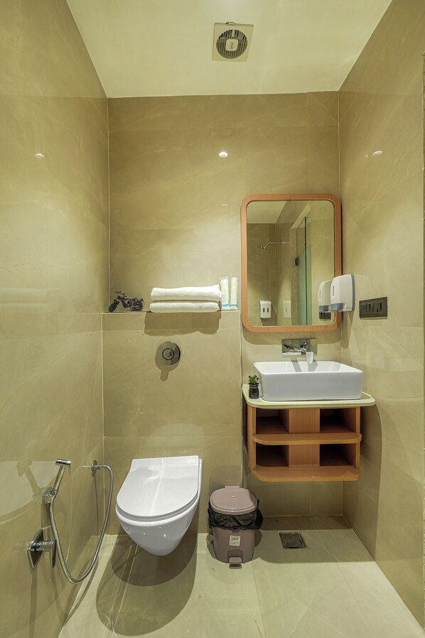 A modern bathroom with a toilet, bidet, and sink. - Hotel Sign Inn (Amritsar)
