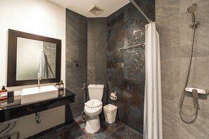 A bathroom with a white sink, toilet, and shower. - Blu Monkey Boutique Naiharn Beach (Rawai)