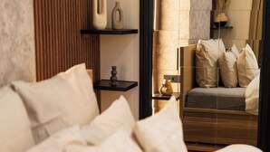A modern bedroom with a bed, pillows, a nightstand, and a vase. - Cozy 5BR Apt in the Heart of Ghent (Ghent)