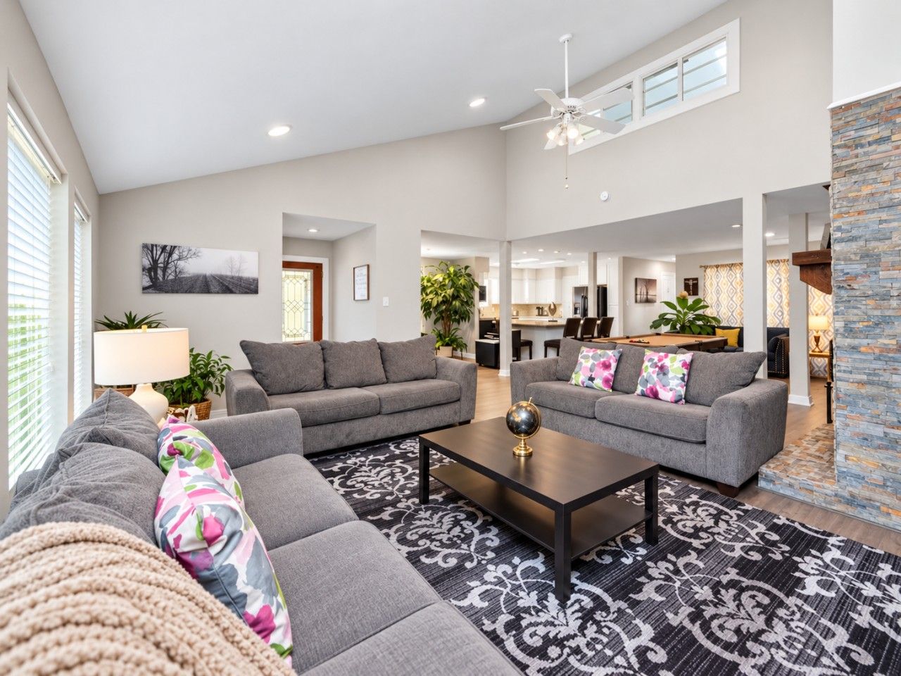 Gather, relax, and reconnect in this bright, spacious living room with vaulted ceilings, comfortable seating, and an open layout perfect for spending time together.