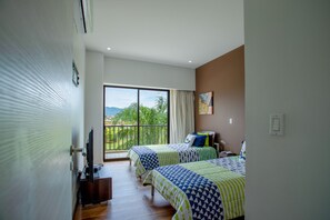 A hotel room with two beds, a TV, and a balcony with a view. - Jaco Bay 4303 (Jacó)
