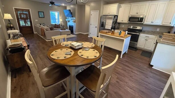 A dining area with a wooden table, four chairs, and placemats.
