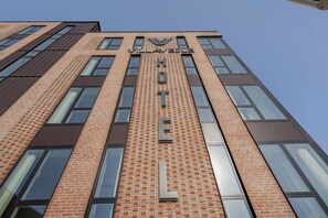 A tall brick building with large windows and the words 'VILLAVESLE HOTEL' prominently displayed. - Villavejle Hotel, BW Signature Collection (Vejle)