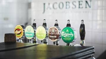 A bar with beer taps labeled with different beer brands.