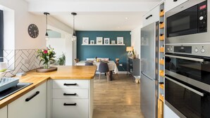 A modern kitchen with a wooden countertop, white cabinets, and a built-in oven. - Family Friendly 3 Bed Home - Pass the Keys (Leamington Spa)