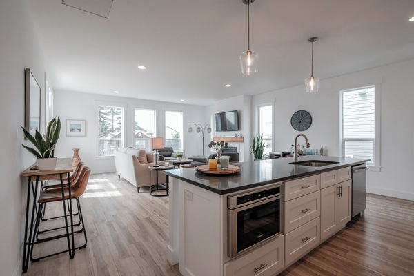 A fully equipped kitchen with stainless-steel appliances, and additional seating, thoughtfully designed for effortless hosting.