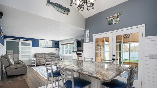 A spacious living area with a dining table, chairs, a sofa, and a massage chair. - Beautiful, spacious luxury home in Michigan for 12
. (Wyoming)