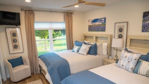 A bedroom with two beds, a TV, and a view of a garden. - Classy Country Guest House close to Canton First Monday (Wills Point)