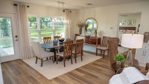 A dining area with a wooden table, chairs, and a vase of flowers. - Classy Country Guest House close to Canton First Monday (Wills Point)