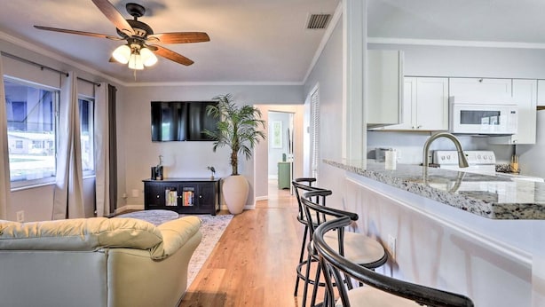 A modern kitchen with white cabinets, a granite countertop, and a stainless steel sink. - Blue Oasis 5512, Your Private Getaway (Bradenton)