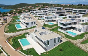 A modern residential complex with multiple two-story houses, each featuring a swimming pool and solar panels. - Awesome home in Ugljan with private swimming pool, can be inside or outside (Ugljan)