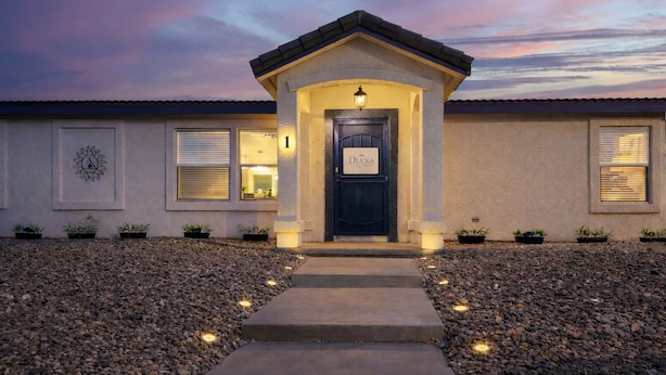 A building with a dark entrance door, a small porch, and a pathway leading to the door. - Large King Bedroom/55" TV/Big fenced yard w games/Dogs welcome/Boat parking (Page)