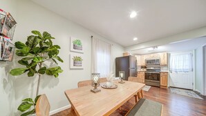 A modern kitchen with wooden cabinets, a built-in oven, and a microwave.