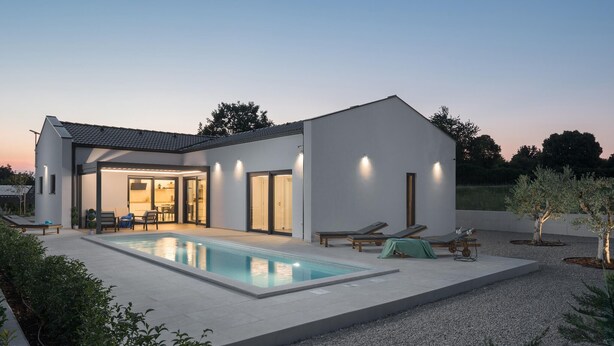A modern house with a swimming pool, outdoor seating, and a well-lit patio area. - Gorgeous home in Sveti Petar u Sumi (Sveti Petar u Sumi)