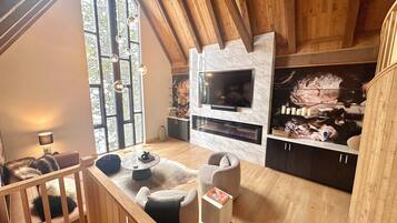 Smart TV, fireplace, books, printers