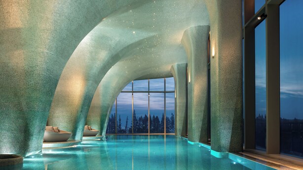 A modern indoor pool with a clear view of the sky and trees, surrounded by textured walls. - Intercontinental Huzhou Taihu South By Ihg (Huzhou)