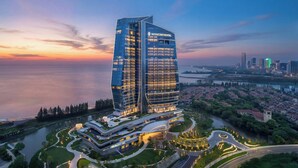 A modern hotel with a unique architectural design, situated by a waterfront. - Intercontinental Huzhou Taihu South By Ihg (Huzhou)