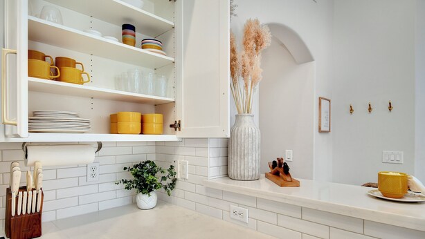 A kitchen with white cabinets, a white countertop, and a potted plant. - Modern Japandi Home with Fire-Pit Evenings and Fast Internet (Meridian)