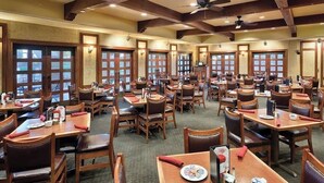 A restaurant with multiple tables and chairs, wooden beams on the ceiling, and large windows. - Wyndham 1-Bedroom Studio in a Premier Resort with Full Amenities (Phoenix)