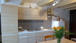 A modern kitchen with light wood cabinetry, a stainless steel sink, and a white refrigerator. - MAISON ROSALICE - Chaumont-la-Ville (Chaumont-la-Ville)