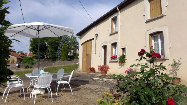 A patio with outdoor seating, a white umbrella, and potted plants. - MAISON ROSALICE - Chaumont-la-Ville (Chaumont-la-Ville)