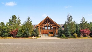 A lodge with a wooden exterior, stone foundation, and a prominent entrance. - Roslyn Pines: Hot Tub, Spacious Deck, Dogs Welcome, Family Friendly! (Ronald)