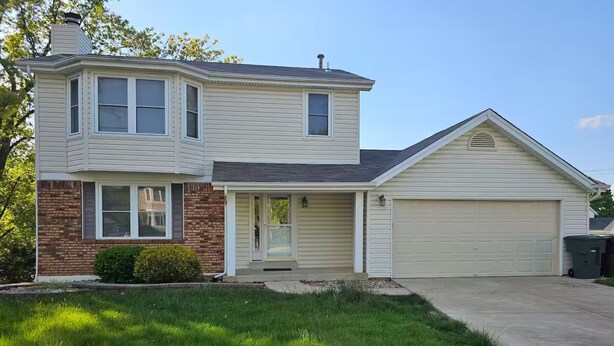 A two-story house with a garage, a front porch, and a brick foundation. - Shagbark - 7 Beds - 4 Baths (St. Peters)