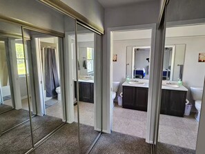 A modern bathroom with a glass shower enclosure, a white sink, and dark cabinetry. - Shagbark - 7 Beds - 4 Baths (St. Peters)