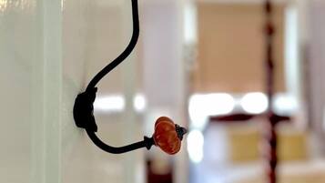 A wall-mounted hook with two orange decorative elements.
