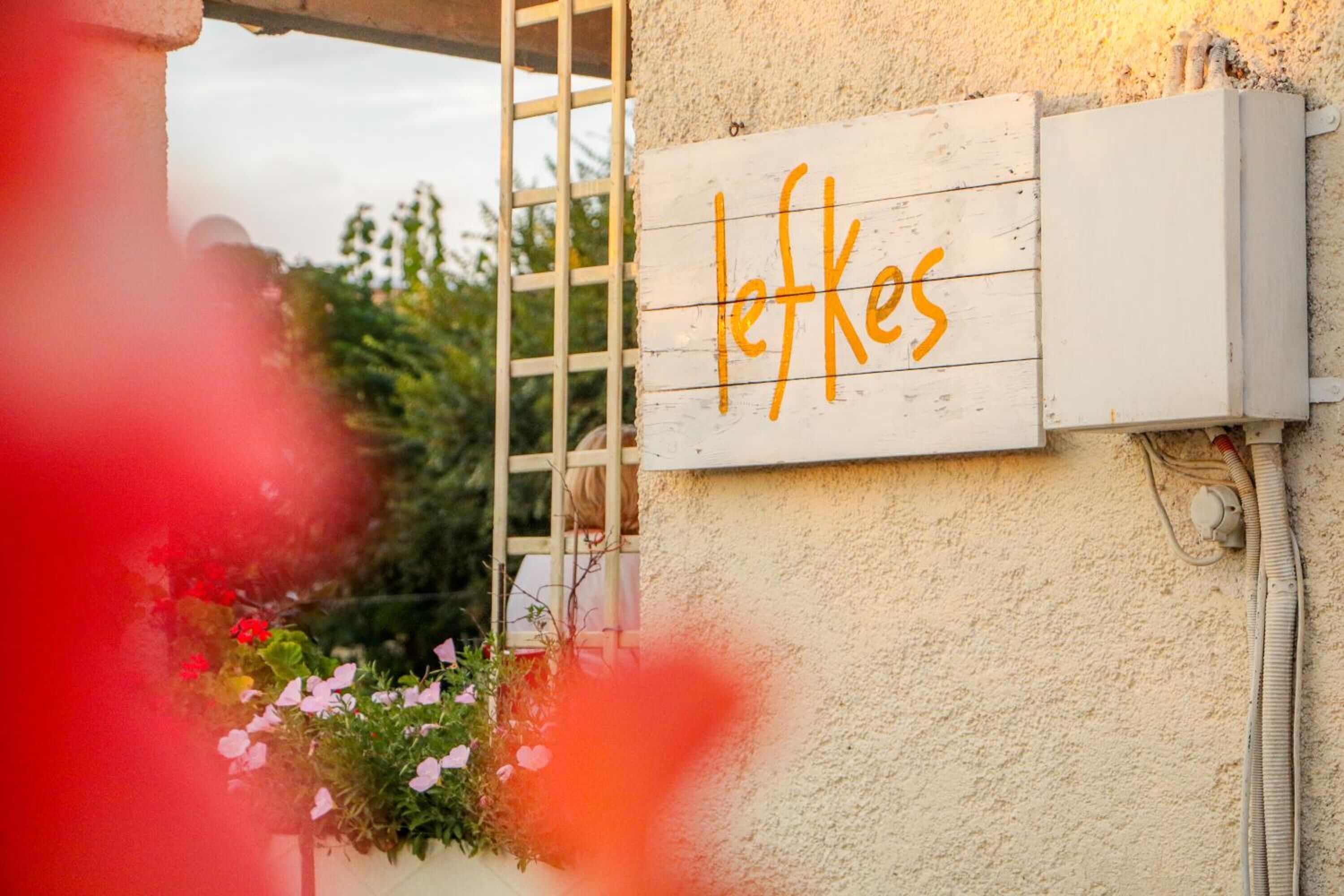 A sign with the name 'leffkes' on a building's exterior wall.