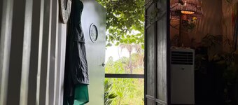 Luxury off-grid passionfruit covered shipping container immersed in nature.