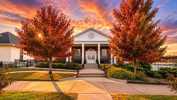 A building with a central entrance, flanked by two trees, and a pathway leading to the entrance. - Bright & Cozy Church Conversion • 1BR (Nashville)