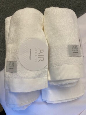 A stack of white towels with 'AIR COTTON Buddemeyer' labels. - Studio Beach Copacabana - 5 min from the beach - Wi-Fi - 5 min from the subway - Brand New (Rio de Janeiro)