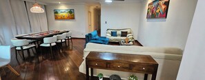 A dining area with a wooden table and chairs, a sofa, and a decorative bench. - Experience vibrant city living, steps away from all that Quito has to offer (Quito)