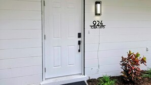 A white door with a number plaque reading '924' and the name 'TORIA SUITES' above it. - Toria Suites Condo 924 (Lakeland)