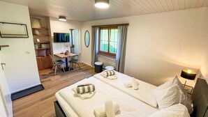 A hotel room with a bed, a desk, and a TV. - La Siala Apt.21 by Interhome (Falera)