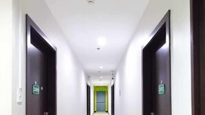 A long, narrow hotel corridor with doors numbered 309 and 302, leading to rooms. - Asia Jem Hotel - Bacolod City (Bacolod)