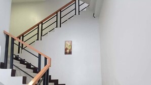 A staircase with white steps and black edges, leading to an upper floor. - Asia Jem Hotel - Bacolod City (Bacolod)