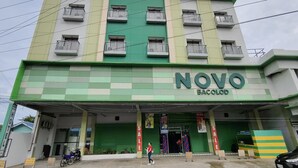 A hotel named NOVO BacoLod with a green and white facade, multiple balconies, and a visible entrance. - Asia Jem Hotel - Bacolod City (Bacolod)