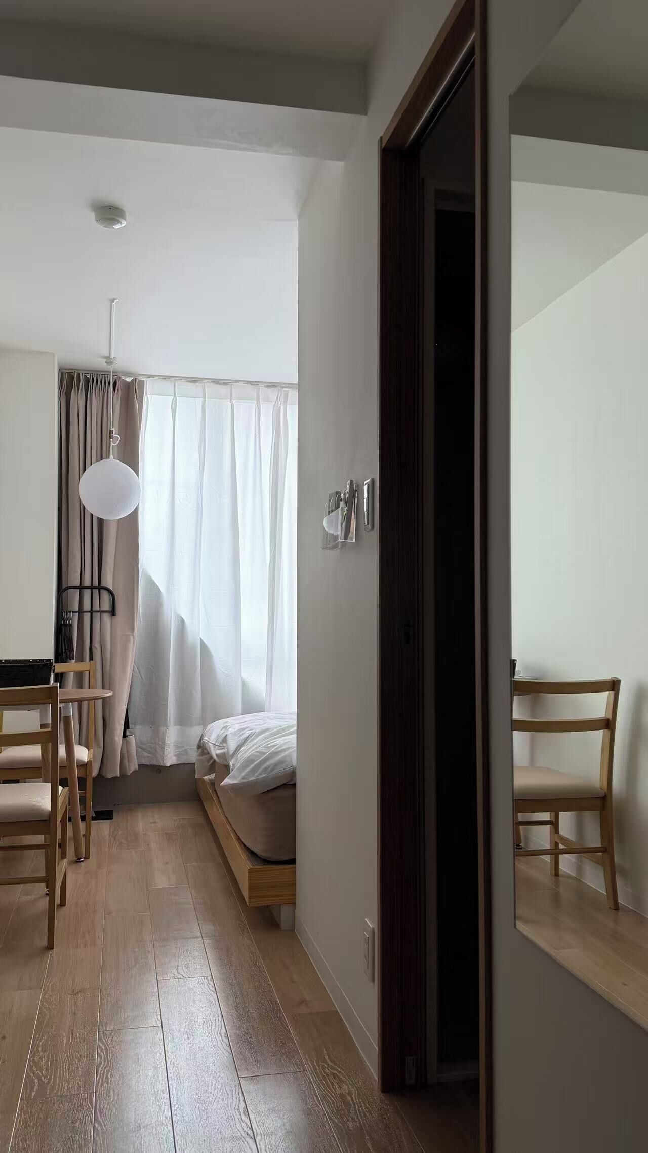 A bedroom with a bed, a desk, a chair, and a wardrobe.