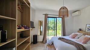 A bedroom with a bed, a wardrobe, a television, a mirror, and a view of the outdoors. - 1 Double Room 2 pers, Residence Casa Pian d'Olmo / Double Room - A Leccia (Olmiccia)