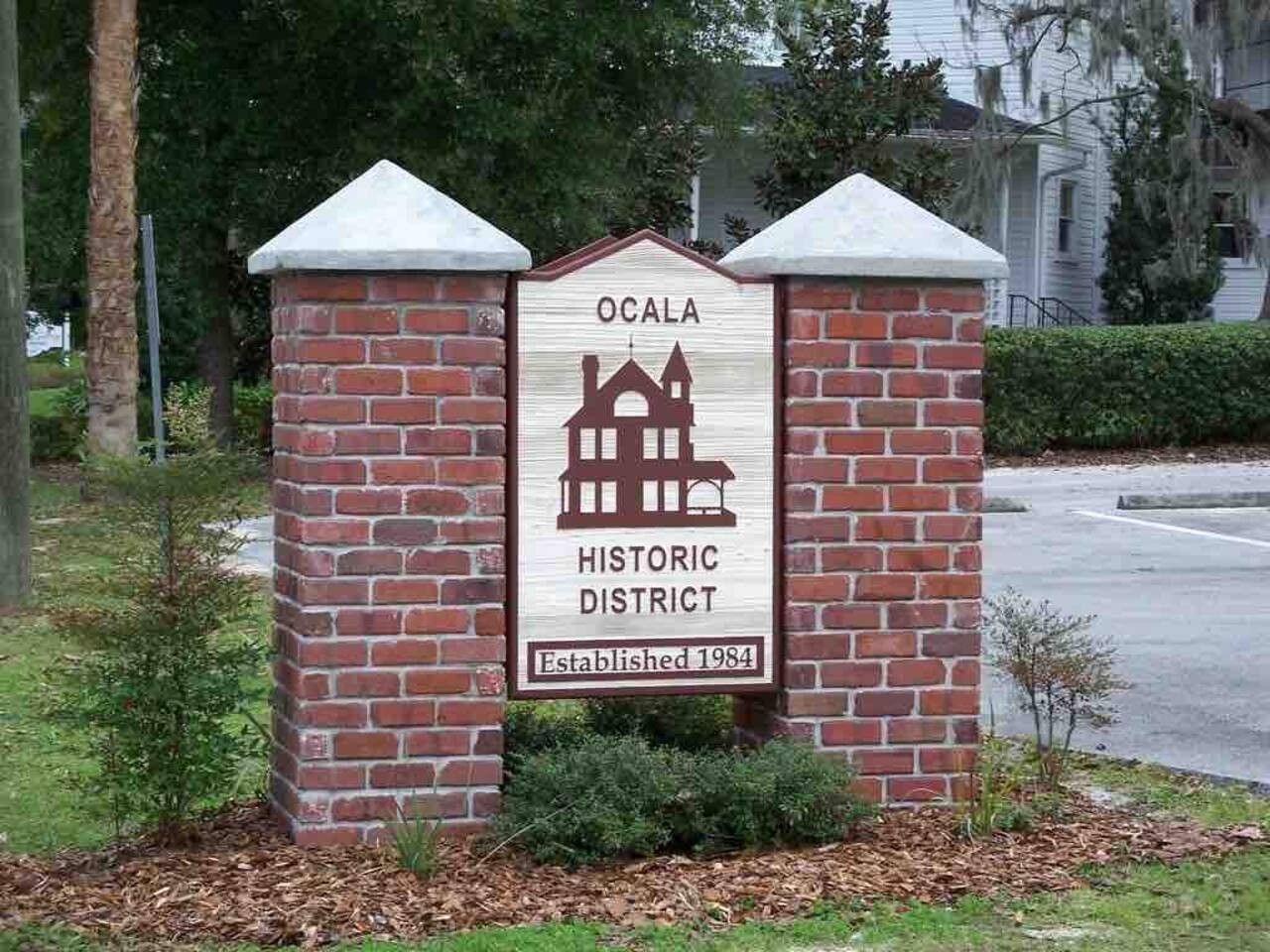 A brick sign with a white background, featuring a building illustration and the text 'OCALA HISTORIC DISTRICT Established 1984'.