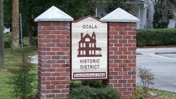 A brick sign with a white background, featuring a building illustration and the text 'OCALA HISTORIC DISTRICT Established 1984'.