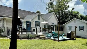 A residential property with a fenced backyard, a covered patio, and a small pool. - Historic Downtown Apt with hot tub-walk downtown (Ocala)