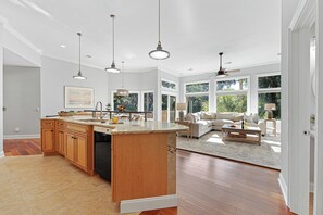 A spacious kitchen with wooden cabinets, a central island, and pendant lighting. - Pet Friendly Palmetto Dunes Home w/ Private Pool, Game Room & Golf Views (Hilton Head Island)