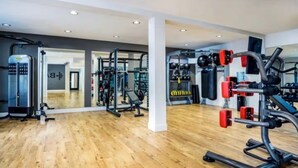 A gym with various exercise equipment, wooden flooring, and mirrors. - Luxe Marina Escape-Near SoFi & Beaches (Marina del Rey)