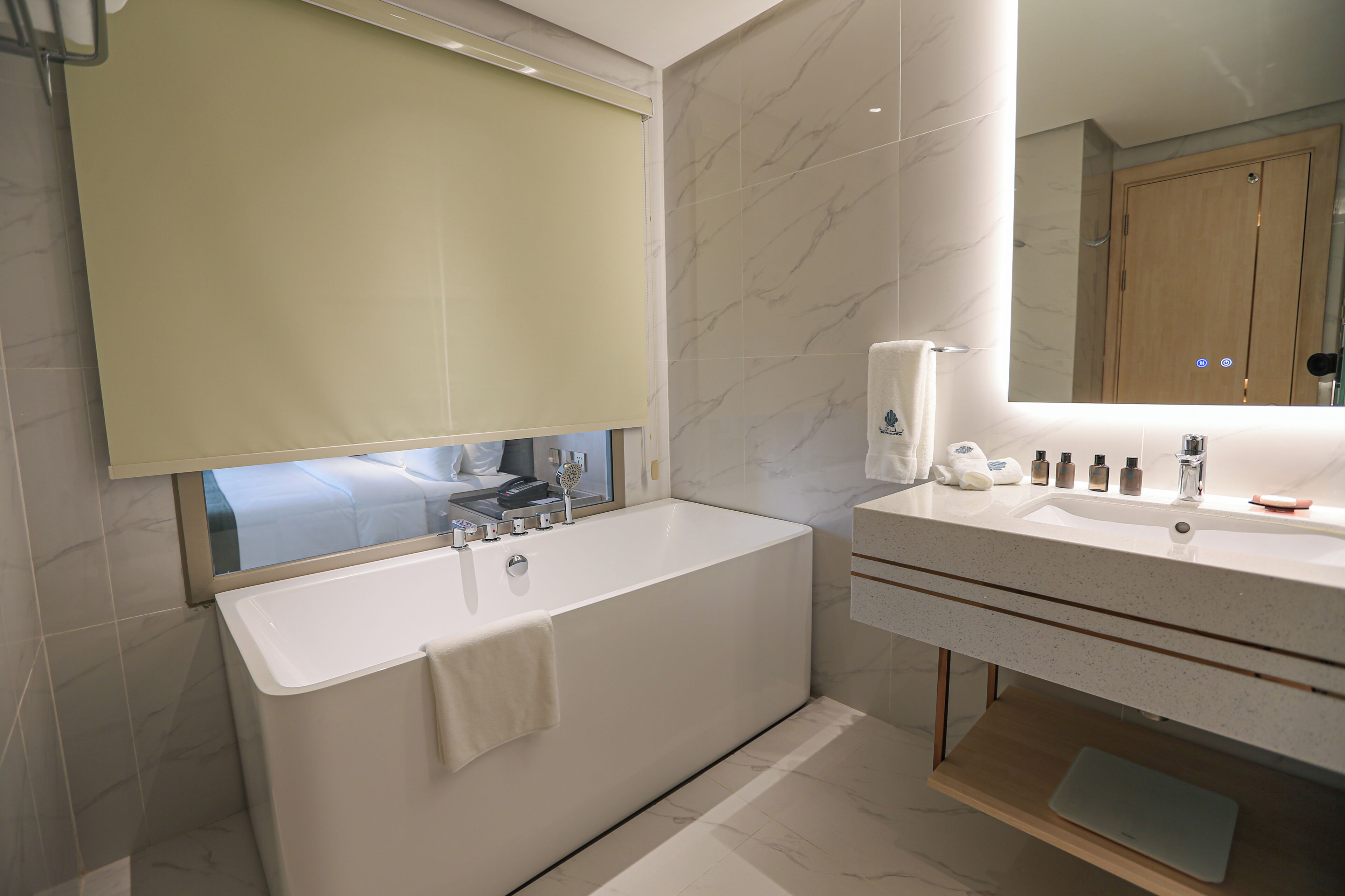 Une salle de bain moderne avec une baignoire, un lavabo et un miroir.