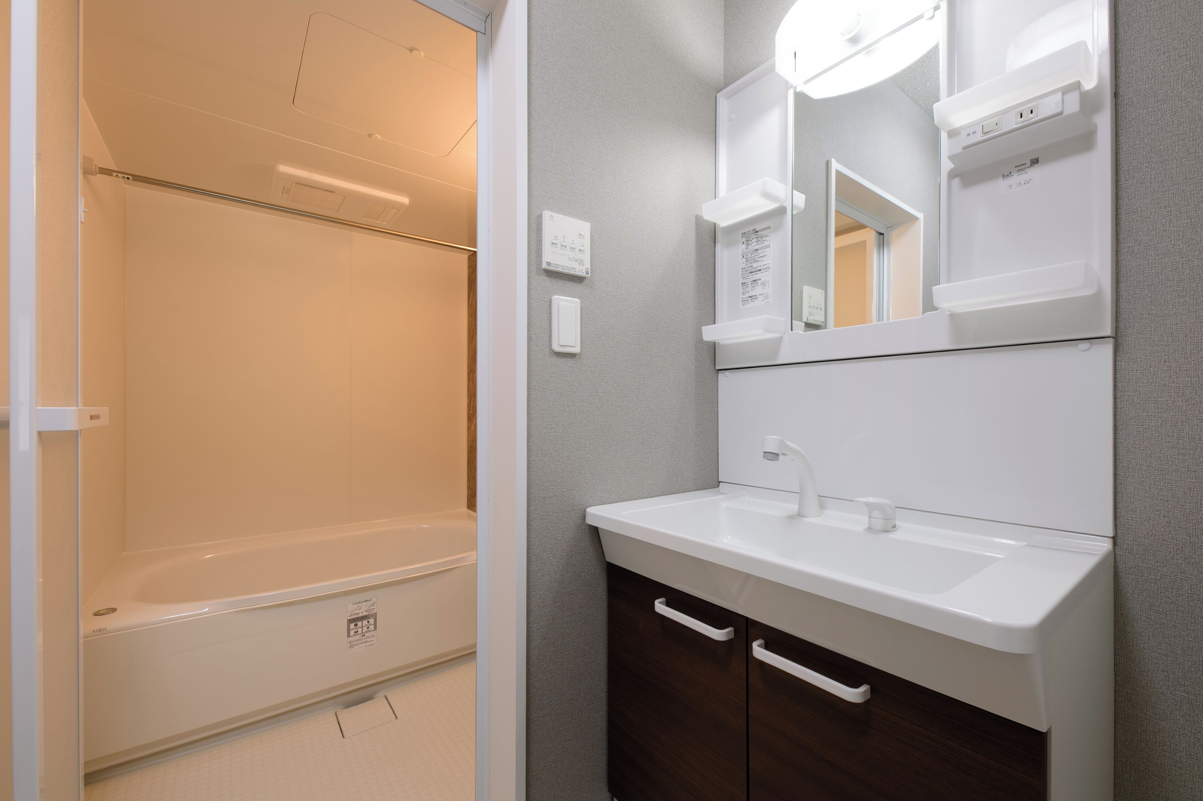 A modern bathroom with a bathtub, a sink, and a mirror.