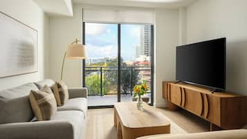 1 Bedroom Executive Suite w/ Balcony | Living area | 55-inch Smart TV with cable channels