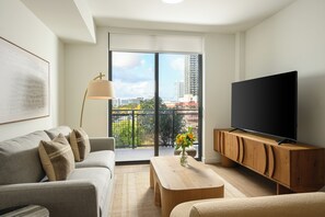 1 Bedroom Executive Suite w/ Balcony | Living area | 55-inch Smart TV with cable channels